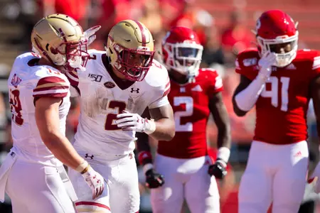 AJ Dillon heads back to the huddle after a run at Rutgers