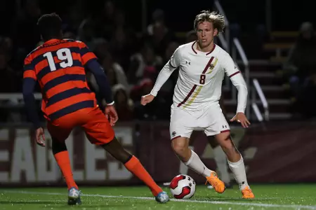 Lasse Lehmann dribbles up field against a defender from Syracuse ion Nov. 1, 2019