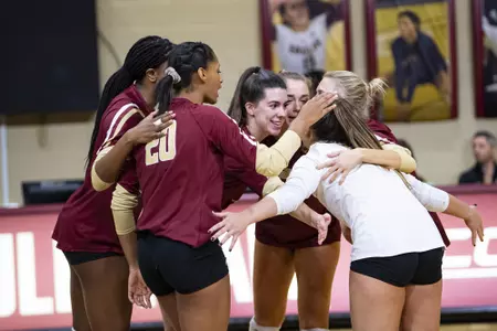 The volleyball team celebrates in Power Gym