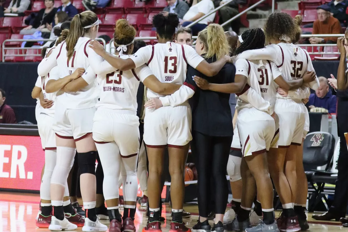 The women's basketball team huddles during a timeout