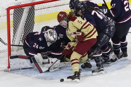 Savannah Norcross battles for the puck against UConn.