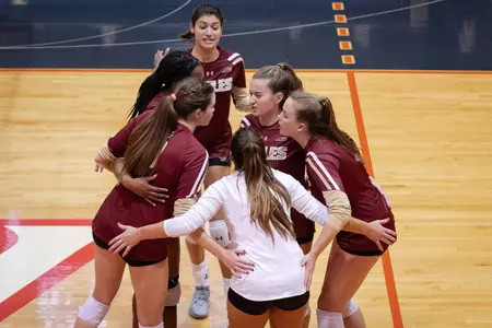 The volleyball team huddles at Virginia