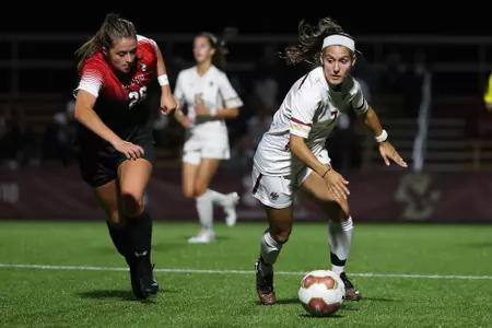 Gabby Carreiro dribbles the ball up the field against Northeastern.