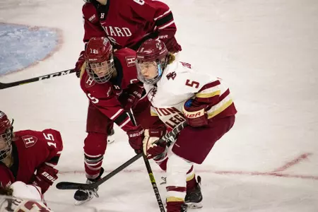 Savannah Norcross battles for the puck against Havard.