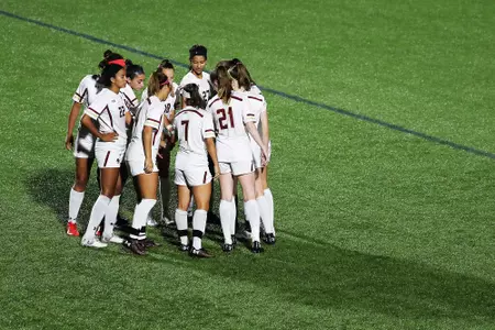 Women's soccer in a team huddle before playing Providence.