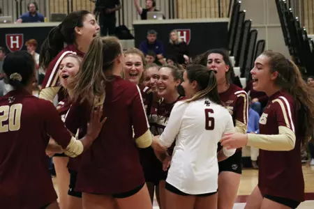 the volleyball team celebrating a win over Harvard