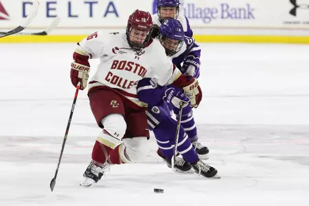 Alexie Guay battles for the puck against Holy Cross.