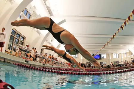 Female swimmers begin a race at the Connell Center