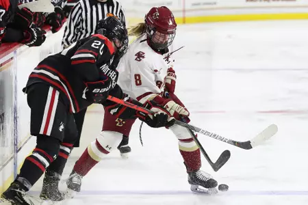Hadley Hartmetz battles for a puck against Northeastern.