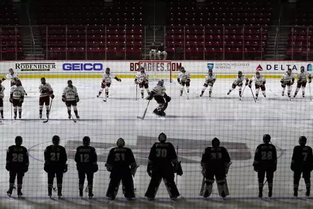 The team skates to the blue line during pre-game announcements.