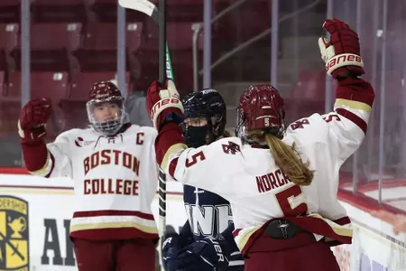 Kelly Browne and Savannah Norcross celebrate a goal against UNH.