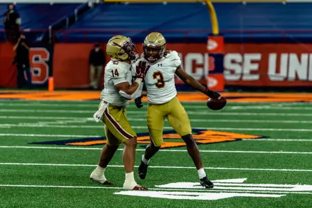 Jason Maitre runs to the sideline following an interception at Syracuse