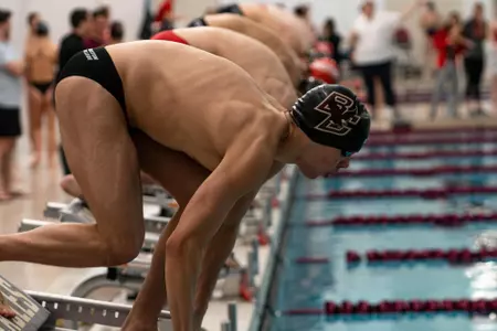 Men's swimmers get ready to begin a race at the Connell Center