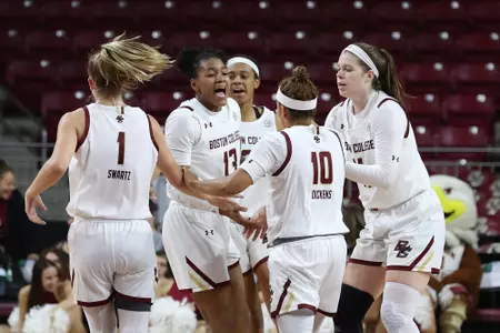 Taylor Soule is greeted by teammates at a timeout - Dec. 20, 2019