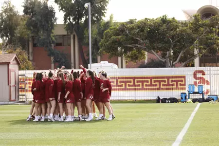 The lacrosse team huddles pregame at USC