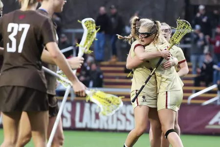 Kate Taylor and Cara Urbank hug after a goal against Brown