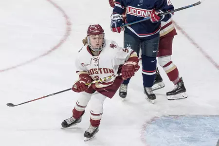 Savannah Norcross skates for the puck against UConn.