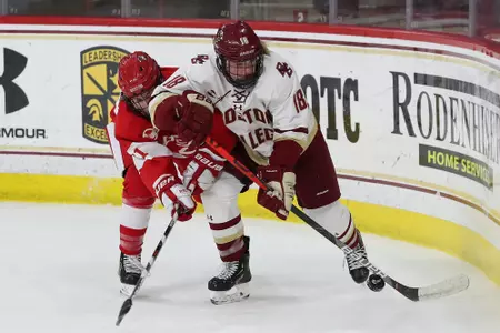 Kelly Browne battles for the puck against BU.