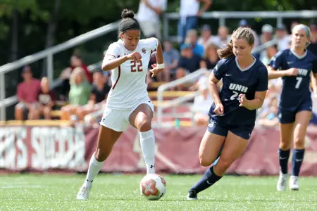 Jillian Jennings dribbles up the field against UNH.