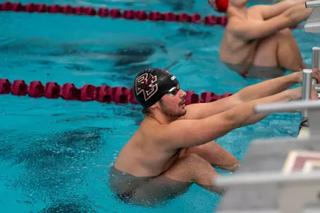 Men's swim gets ready to start a race at the Connell Center