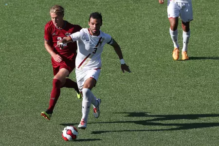 Junior David Longo carries the ball up field vs. UMass, Nov. 2019.