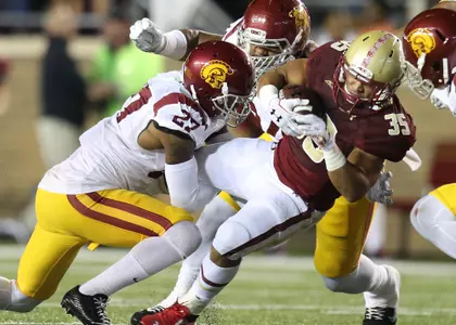 Tyler Rouse is surrounded by USC defenders on a carry in the Eagles' 2014 win.