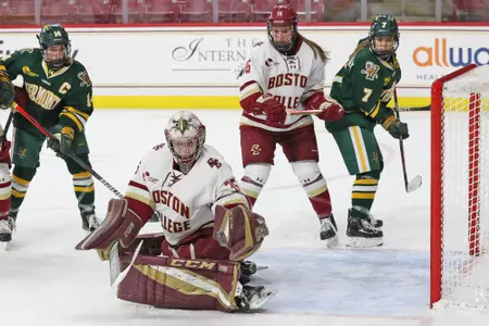 Maddy McArthur makes a save while Alexie Guay looks on.