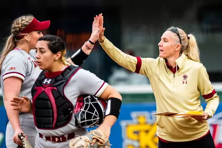 Coach Amy Kvilhaug high fives Suzanna Anderson in between innings, 2020