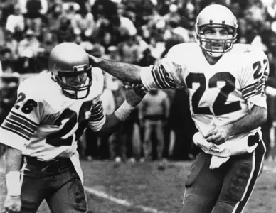 Doug Flutie pictured with a teammate on the field.