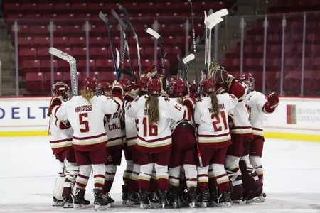 The team gathers at center ice after defeating Holy Cross.