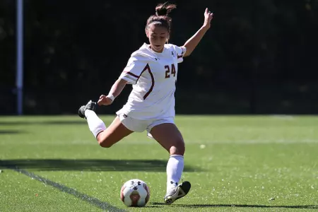 Mia Karras looks to kick the ball.