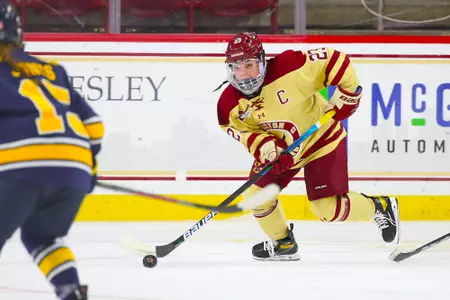 Cayla Barnes skates the puck up the ice against Merrimack.