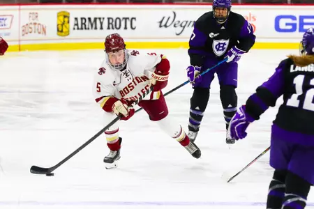 Savannah Norcross carries the puck down the ice against Holy Cross.
