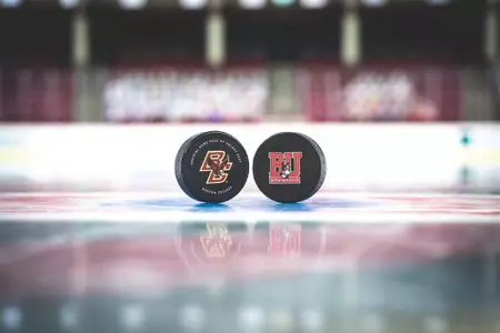 A BC puck (left) and a BU puck (right) on the ice at Kelley Rink.