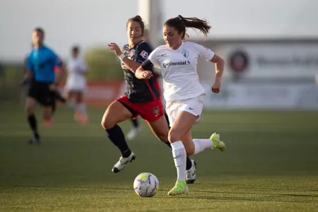 McKenzie Meehan runs up the field with the ball during a game for the NC Courage.