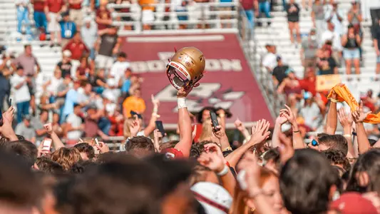 Trae Barry helmet above the fans on the field following OT win over Missouri.