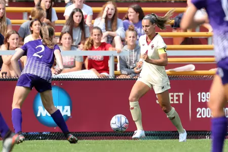 Jenna Bike carries the ball up the field against Holy Cross.