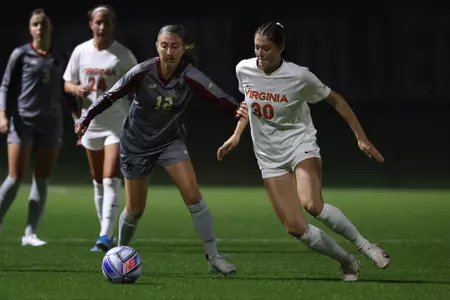 Megan Crevoiserat battles for the ball against Virginia.