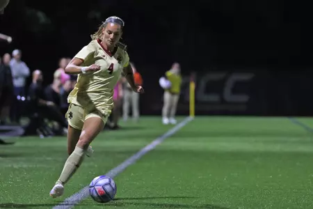 Jenna BIke takes the ball up the field against Miami.