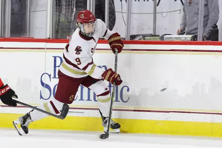 Maddie Crowley-Cahill dumps the puck into the zone.