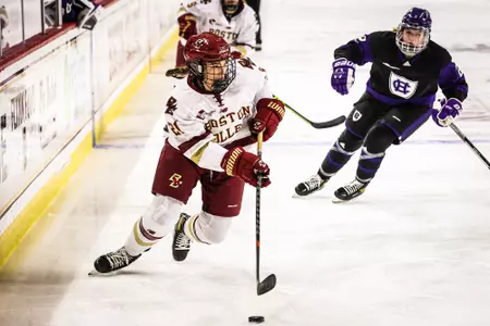 Abby Newhook carries the puck against the Crusaders.