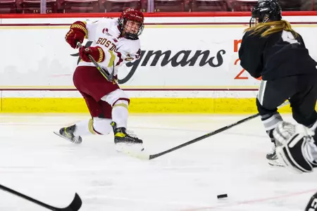 Jenna Carpenter shoots the puck against Providence.