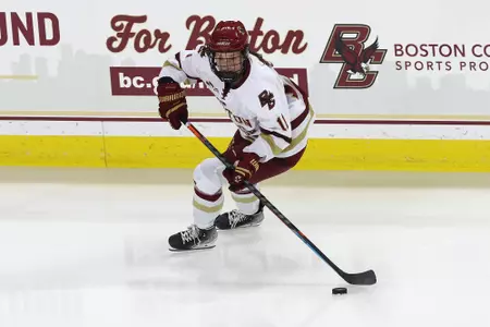 Katie Pyne looks to pass the puck in the offensive zone.