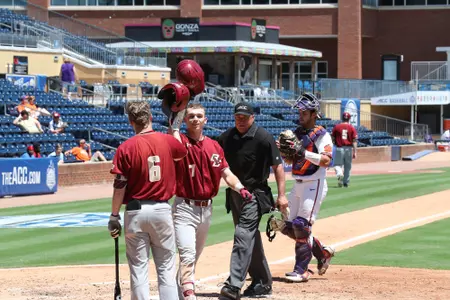 Cody Morissette is greeted at home plate by Brian Dempsey following his home run vs. Clemson at the 2019 ACC Tournament.