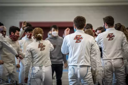 The fencing team huddles up before taking on Sacred Heart.