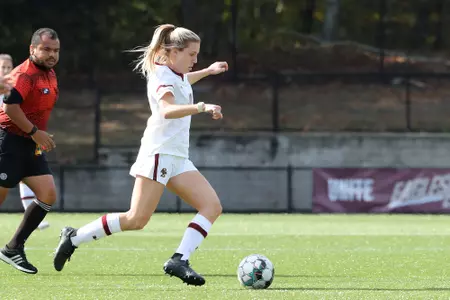 Emily Knous dribbles the ball up the field.
