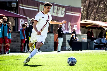 Alex Mieles looks to turn the ball up field against Louisville.