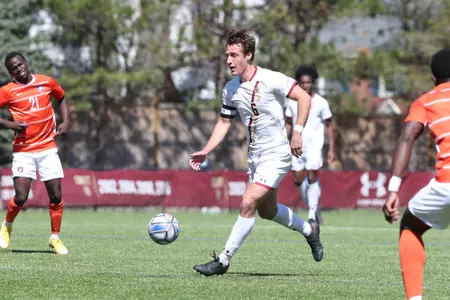 Ian Buehler carries the ball up field against Syracuse.