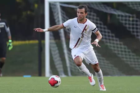 David Longo dribbles the ball up the field.