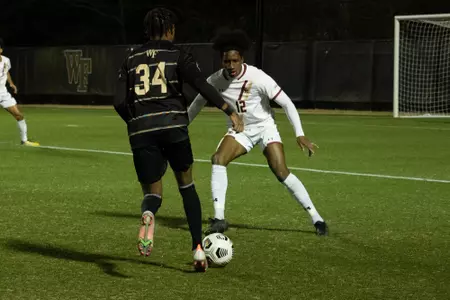 Will Jacques defends the ball against Wake Forest.